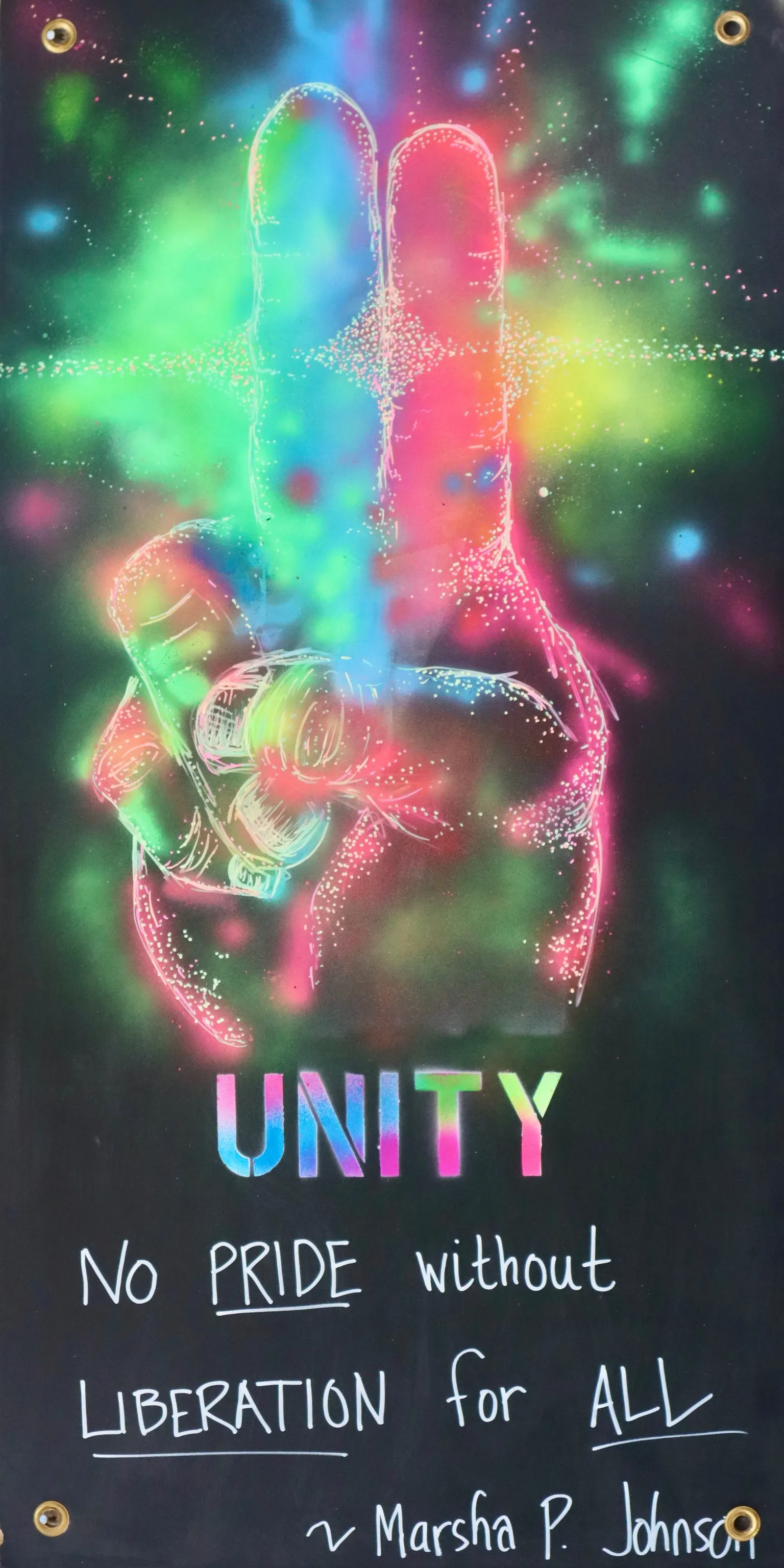 A psychedelic blacklight ASL art panel from Camp ASL Love. Glowing neon lines on a black cosmic background form a hand signing the letter U — index and middle fingers raised together — awash in pink, green, blue, and yellow. Below, stenciled rainbow letters read UNITY, with hand-lettered white text: 'No PRIDE without LIBERATION for ALL ~ Marsha P. Johnson.'